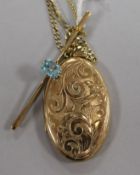 A 9ct gold bar brooch set with a topaz and a 9ct gold engraved oval locket on 9ct gold chain, 18.2gt