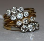 Four assorted 18ct gold and three stone diamond rings.