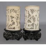 A pair of Chinese carved ivory tusk reticulated vases, carved with dragons among clouds and with