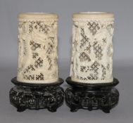 A pair of Chinese carved ivory tusk reticulated vases, carved with dragons among clouds and with