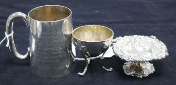 A silver presentation tankard, a small embossed silver circular pedestal dish and a circular