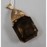 A large yellow metal and emerald cut quartz drop pendant, 53mm.