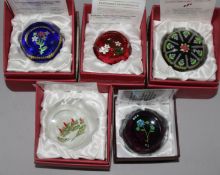 Five Perthshire glass paperweights; four annual collector's editions 1998, 1999, 2000 and 2001 and a