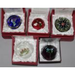 Five Perthshire glass paperweights; four annual collector's editions 1998, 1999, 2000 and 2001 and a
