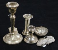 Two silver candlesticks and a small vase (weighted), an Asian embossed white metal small bowl and