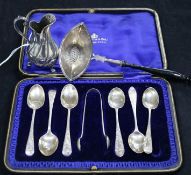 A cased set of six silver teaspoons , a Dutch strainer and a Victorian silver cream jug.