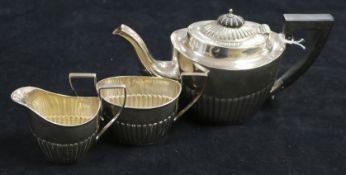 A three-piece silver tea service of oval half-fluted form, Birmingham 1897, John Millward Banks