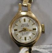 A lady's 9ct gold Swiss Empire manual wind wrist watch on a 9ct gold bracelet.