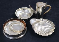 A modern silver wine coaster, two silver coin dishes, a fluted ashtray, a shell butter dish and a