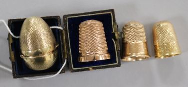 Three 9ct gold thimbles including Charles Horner, Chester, 1922 and one in egg shaped case and one