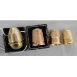 Three 9ct gold thimbles including Charles Horner, Chester, 1922 and one in egg shaped case and one