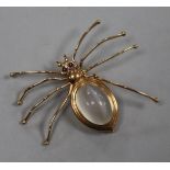 A 14ct gold and gem set spider brooch with chatoyant cabochon quartz body, width 52mm.