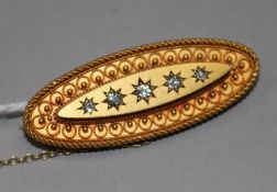 A Victorian oval yellow metal brooch set with five old-cut diamonds
