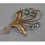 A 14ct gold and aquamarine set foliate spray brooch, 72mm.