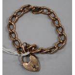 A 9ct gold oval link bracelet with heart shaped padlock clasp, gross 11.1 grams.