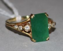 An 18ct gold, emerald and diamond ring, the 2.73ct emerald-cut stone flanked by diamond-set