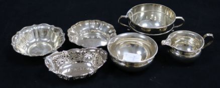 Two circular silver fluted bon bon dishes, a pierced oval bon bon dish, a two-handled sugar bowl and