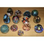 Twelve various glass paperweights, including Orient and Flume, Mdina, Isle of Wight, etc.