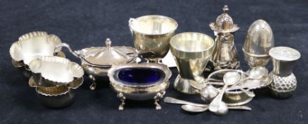 A collection of silver condiments, including four shaped fluted salts and spoons, a three-piece