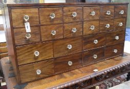 A chemist's chest of drawers, W. 126cm