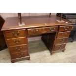 A mahogany kneehole pedestal desk, fitted nine small drawers, W.126cm