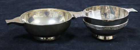 A modern silver quaich with Celtic motifs to handles and raised band and another silver quaich of