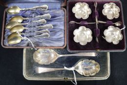 A set of four shaped silver salts and spoons, a pair of silver preserve spoons and a set of six