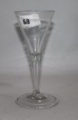 An 18th century wine glass with funnel bowl and tear drop stem