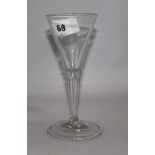 An 18th century wine glass with funnel bowl and tear drop stem