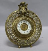 A brass putti mantel clock