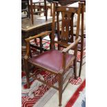 A set of seven Arts & Crafts oak dining chairs, including two carvers