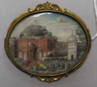An Indian oval miniature watercolour on ivory of a temple, in gilt metal mount