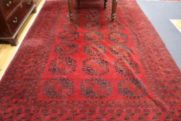 An Afghan red ground rug, 235 x 340cm