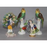 A pair of ceramic parrots, a boy holding a bird and a pastoral figure with basket (4)