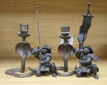 A pair of Japanese bronzed spelter figures of kneeling samurai and a pair of Indian cobra