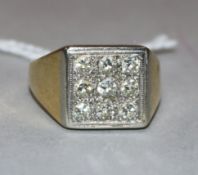 An 18ct gold and nine stone diamond set tablet ring, size O.