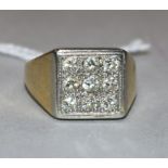 An 18ct gold and nine stone diamond set tablet ring, size O.