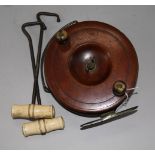 An early 20th Century mahogany fishing reel and two bone and steel boat pulls