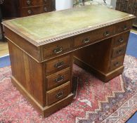 An Edwardian oak pedestal desk, W.122cm