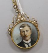 An Edwardian gold framed double sided portrait locket, inset with split pearls, on a gilt metal