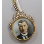 An Edwardian gold framed double sided portrait locket, inset with split pearls, on a gilt metal