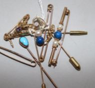 A 9ct gold saxophone stick pin, a similar initial pin and tiepin and five various unmarked items,