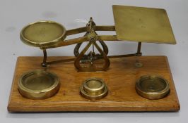 A set of mahogany and brass postal scales and weights