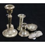 Two silver candlesticks and a small vase (weighted), an Asian embossed white metal small bowl and