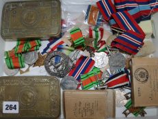 A collection of Military tobacco tins, medals, etc.