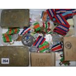 A collection of Military tobacco tins, medals, etc.