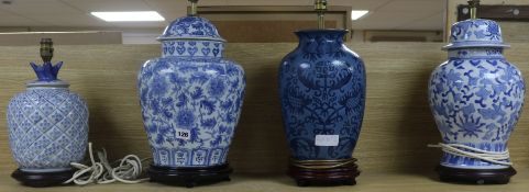 A set of four blue and white table lamp bases