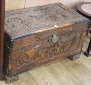 A Chinese relief carved camphorwood coffer, W.100cm