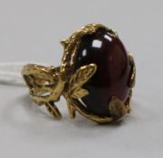 A 9ct gold and cabochon garnet set ring with rustic shank, maker HB, size N.