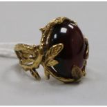 A 9ct gold and cabochon garnet set ring with rustic shank, maker HB, size N.